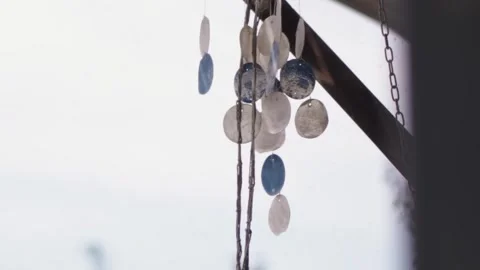 Hanging shell wind chime gently swaying in the wind Stock-Footage 344316427