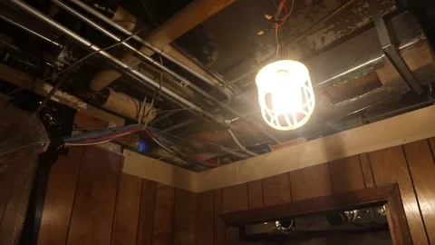 Hanging simple light fixture, ceiling view in room under construction. Stock Footage 97835815