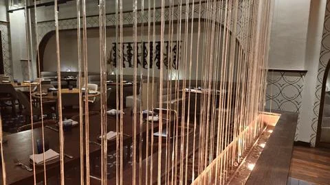 Hanging String Installation in Restaurant Dining Room with Arched Windows Stock Photos