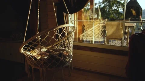 Hanging swing in the house at sunset Stock Footage 200820947