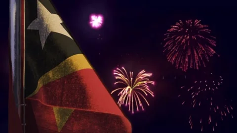 Hanging Timor Leste flag on firework sky bokeh backdrop Stock Footage 237924773