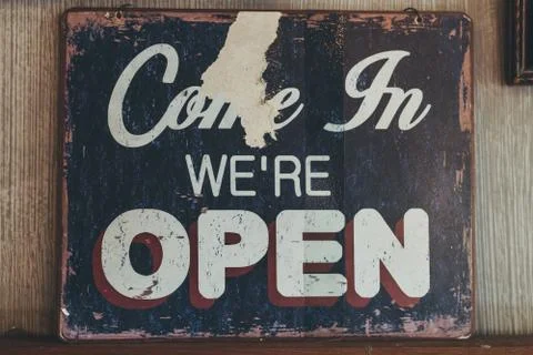 Hanging vintage open sign. Come in we are open. Stock Photos