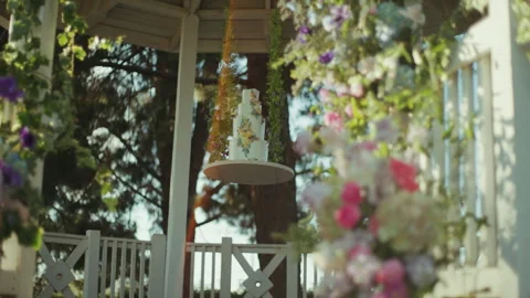 Hanging wedding cake on suspended platform inside garden gazebo Stock-Footage 347969287