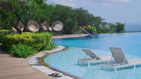 Hanging Wicker And Sunbeds At The Infinity Pools Of Renaissance Bali Stock Footage 281225446