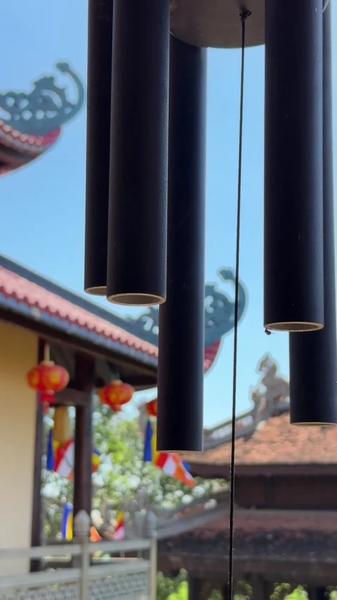 Hanging wind bell moves in the wind near a pagoda roof under open sky. Japanese 库存影片 329615883