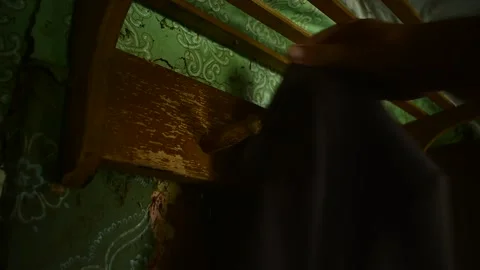 Hangs clothes on a hanger in the interior of an old house, bottom view Vidéo 143258806