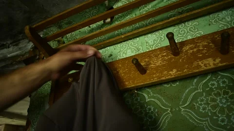 Hangs clothes on a hanger in the interior of an old house Stock Footage 143258933