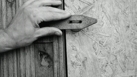 Hangs a lock on the utility room Stock Footage 117473061