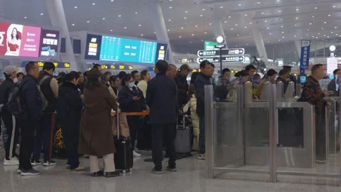 Hangzhou, China - December 11, 2025: A crowd of passengers are waiting in lines Stock Footage 325186053