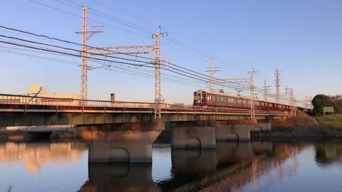 Hankyu train crossing a bridge over a river in Osaka, Japan. Stock Footage 143778678