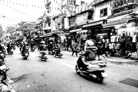 Hanoi, Vietnam - 03/17/2016: Motorcyclists riding on the street B/W Stock Photos