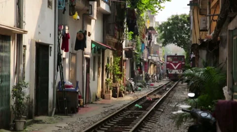 HANOI, VIETNAM - MAY 2014: train passing through slums Stock Footage 40434591