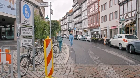 HANOVER, GERMANY - October 2018: Young woman tourist with a backpack walking Stock Footage 109606997