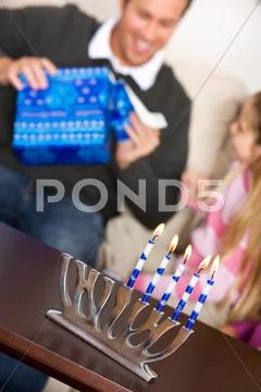 Hanukkah: father opens hanukkah gift Stock Photos