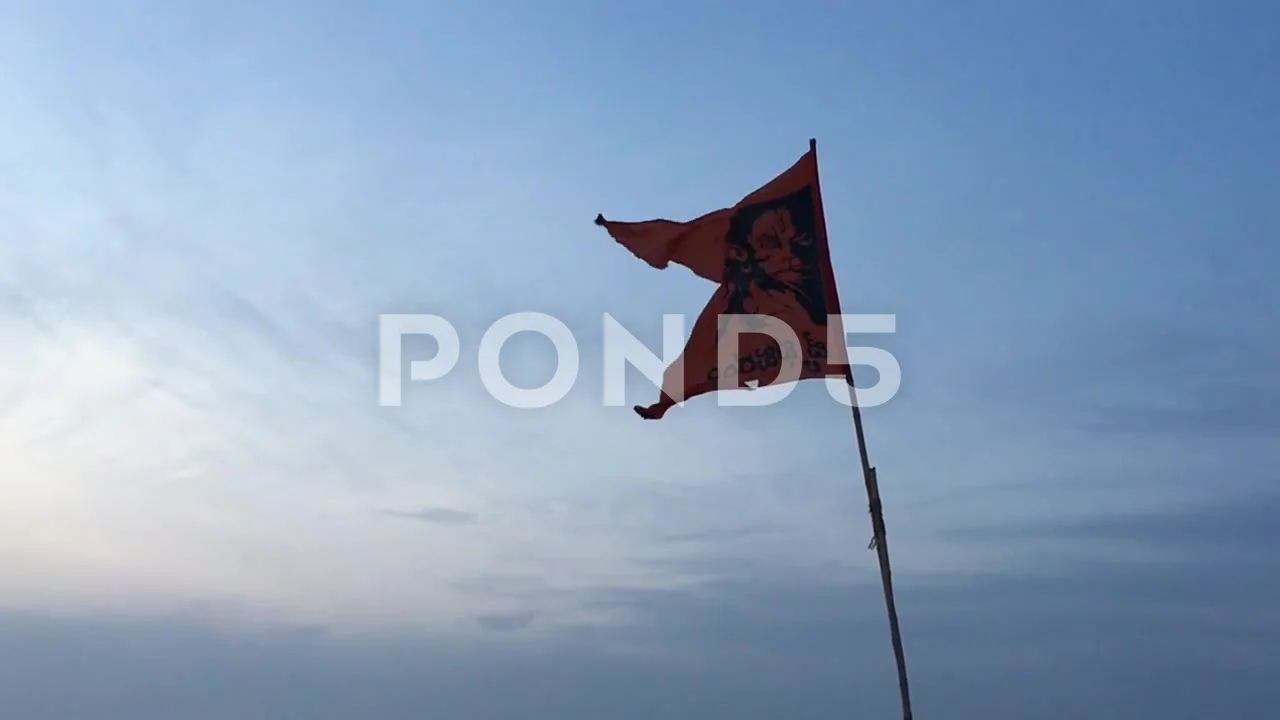 Hanuman Flag Waving On The Top Of A Building Under The Blue Sky Stock Photo  - Download Image Now - iStock