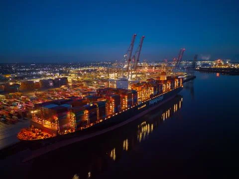 Hapag-Lloyd container ship lights at night at Southampton Docks UK aerial Stock Photos