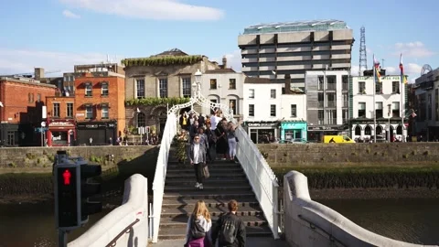 Ha'penny Bridge, iconic landmark bridge in historic downtown Dublin. Irish city  Stock Footage 222158560