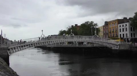 Ha'penny halfpenny bridge Dublin rain pedestrians umbrellas grey sky Stock Footage 65379410
