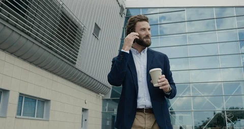 Happily smiling attractive Man talking on his Phone with interest. Business Stock Footage 117689336