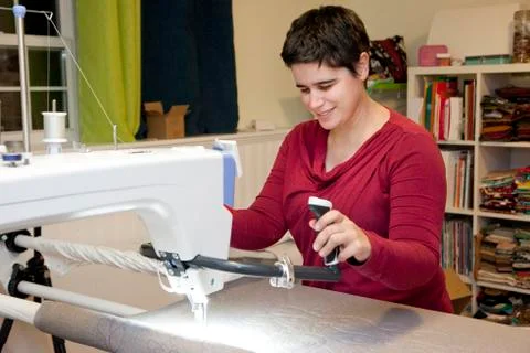 Happily working on sewing project Stock Photos