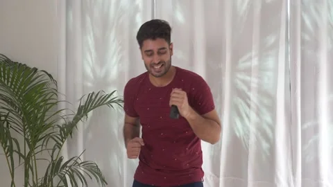 Happy 30s active handsome guy having fun dancing and singing, enjoying indoors. 動画素材 151100732