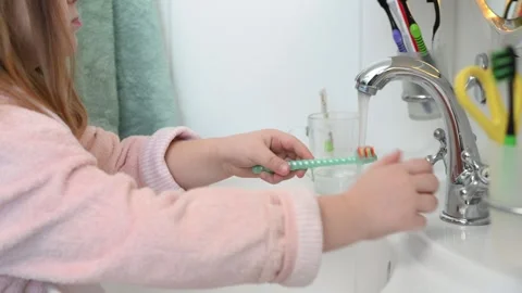 Happy 7 year old child brushes his teeth in the bathroom near the mirror  Stock Footage 270974405
