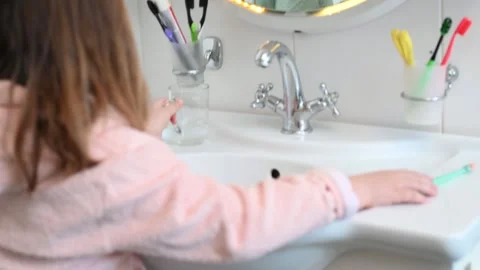 Happy 7 year old child brushes his teeth in the bathroom near the mirror  Stock Footage 270974462