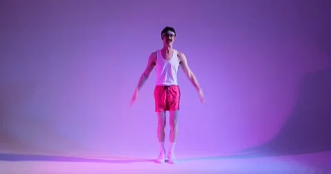 Happy 90s Man Doing Burpee Exercise Over Purple Background Stock Footage 263868843