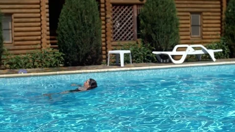 Happy active child jumps to swimming pool. Stock Footage