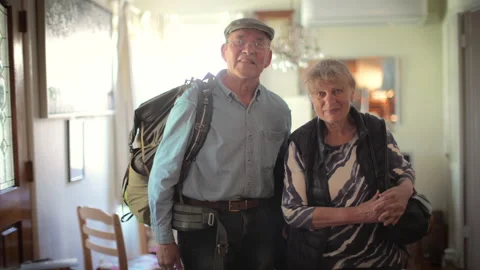 Happy active senior couple standing at home, ready for vacation travel. Stock Footage 274672508