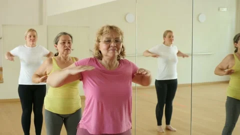 Happy adults training swing steps at dance class Stock Footage 166178432