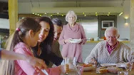 Happy Affectionate Family Group Eating Lunch At Home Stock Footage