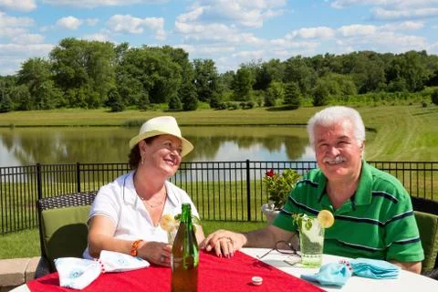 Happy affectionate senior couple on the patio Stock Photos