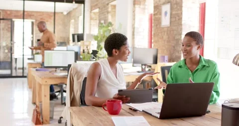 Happy african american colleagues using tablet and discussing work in office, Stock Footage 341319792