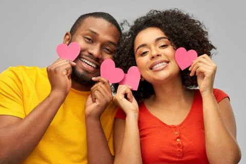 Happy african american couple with hearts Stock Photos