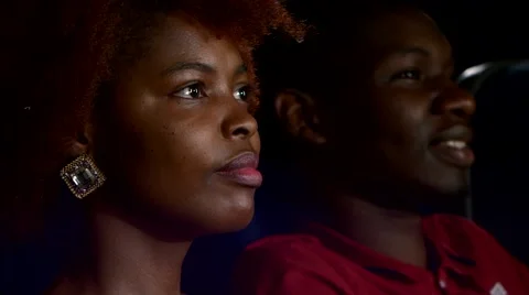 Happy African American couple, watching movie In theatre, Close up Stock Footage