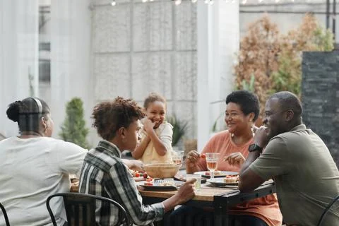Happy African American Family at Dinner Outdoors Stock Photos
