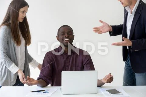 Happy African American worker mediating reaching nirvana at work Stock Photos