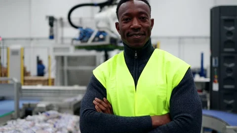 Happy African engineer working at ai robotic automation warehouse - Industrial t Stock Footage 229640009