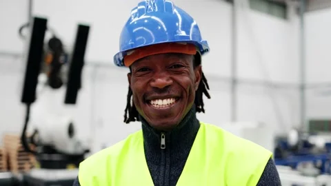 Happy African engineer working at ai robotic automation warehouse - Industry Stock Footage 229640165