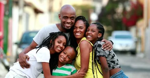 Happy African family portrait standing for photo outside. Cheerful black pare Stock Photos