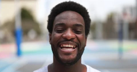 Happy African man smiling at camera inside basketball court Stock Footage 183006691