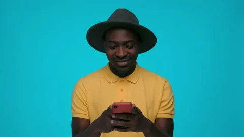 Happy african man using smartphone over blue background Stock Footage 157165324