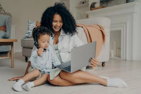 Happy african mom and baby son enjoying video call with family Stock Photos