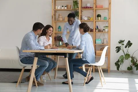 Happy African teacher training group of interns at meeting table Stock Photos