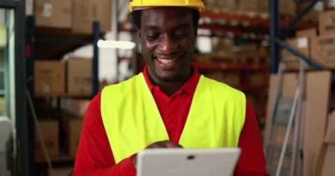 Happy african worker man using tablet inside warehouse 動画素材 145434510