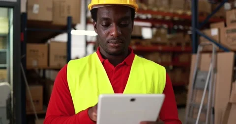 Happy african worker man using tablet inside warehouse Stock Footage 145434528