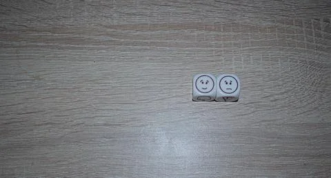 Happy and Angry Faces on Mint Green Dice Stock Photos