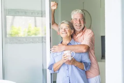 Happy and beautiful retired couple of man and woman caucasian people enjoying Stock Photos
