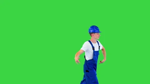 Happy and excited construction worker walking and dancing on a Green Screen Stock Footage 219473369